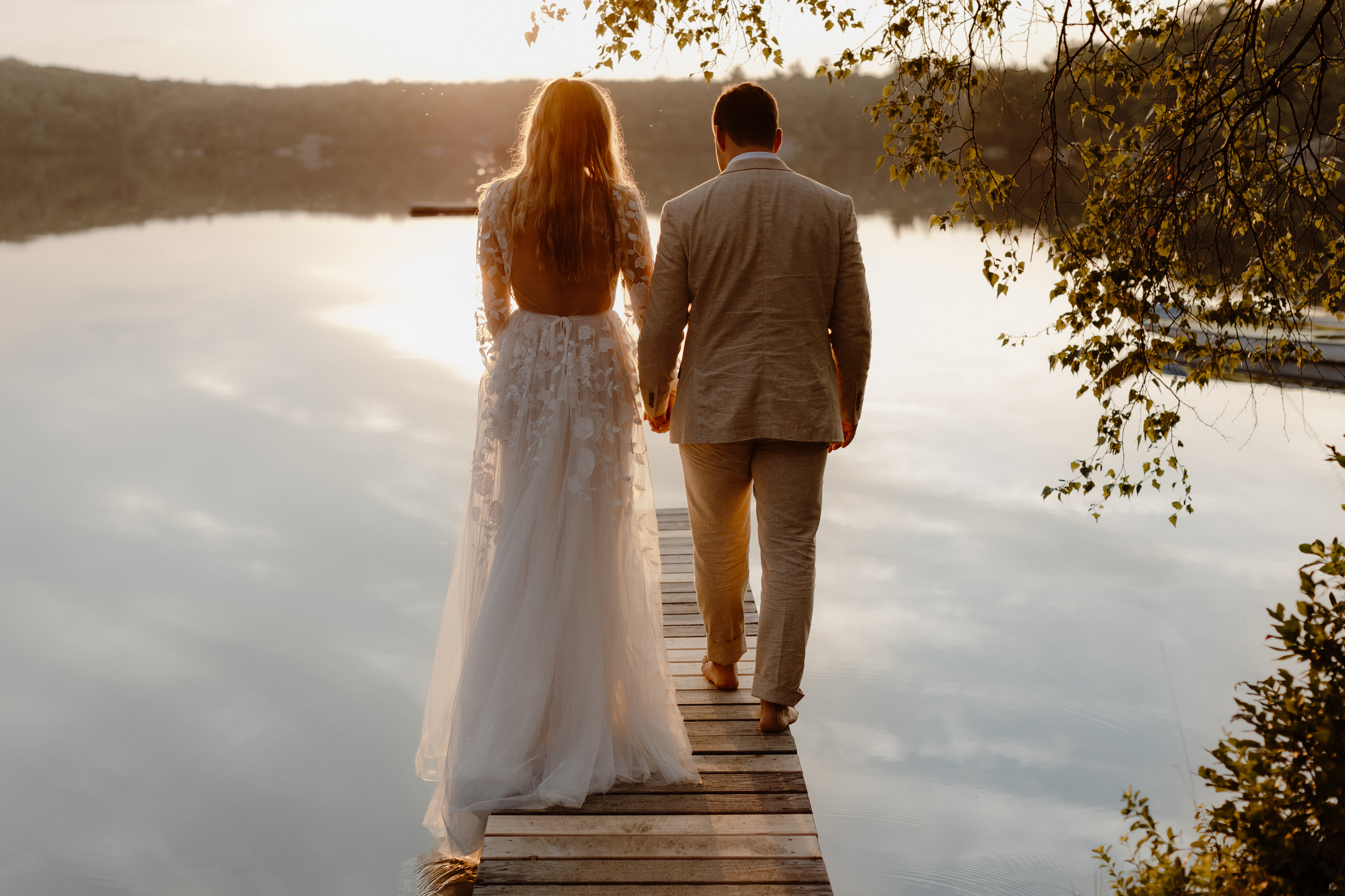 bride and groom walking on dock