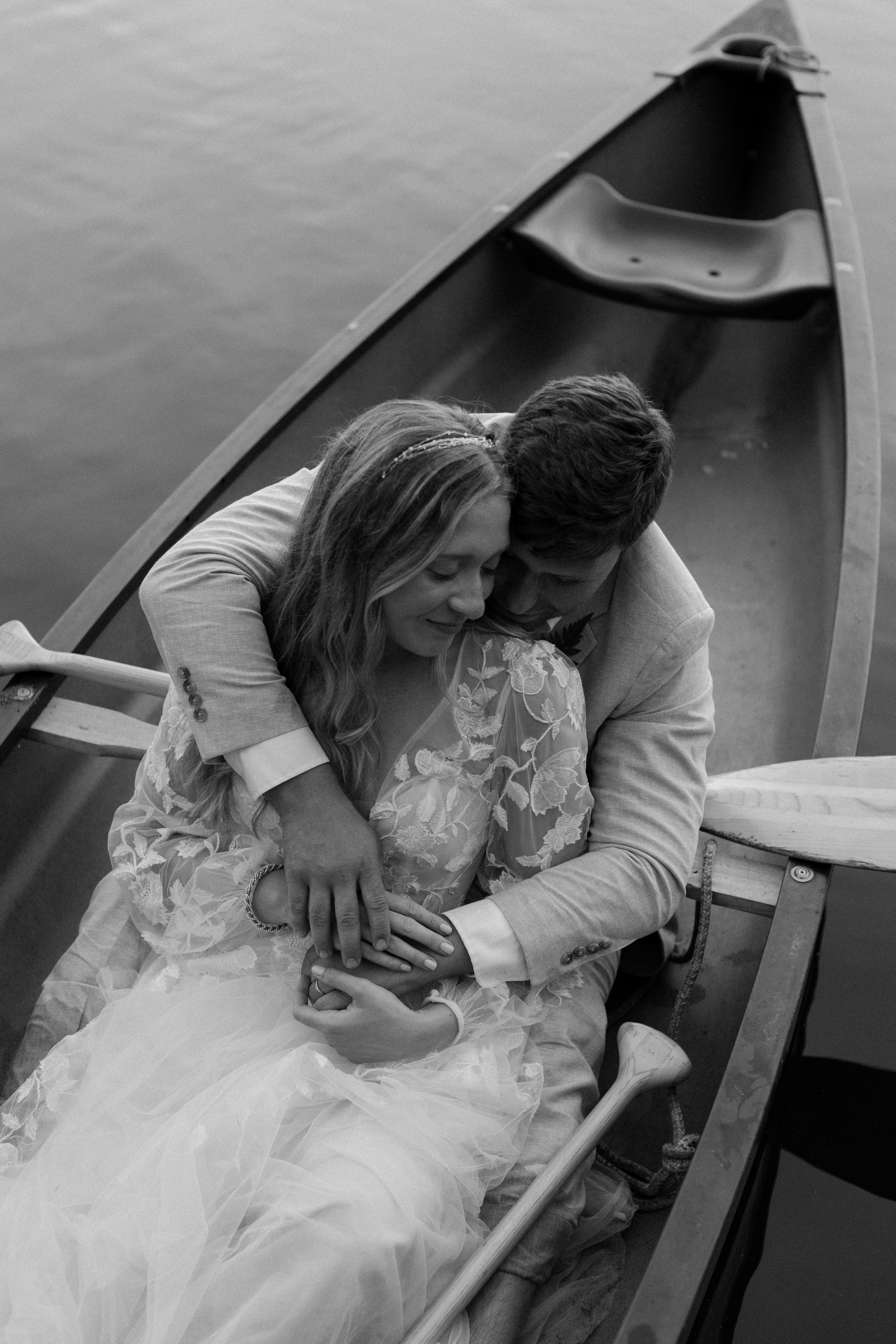 couple embracing on canoe
