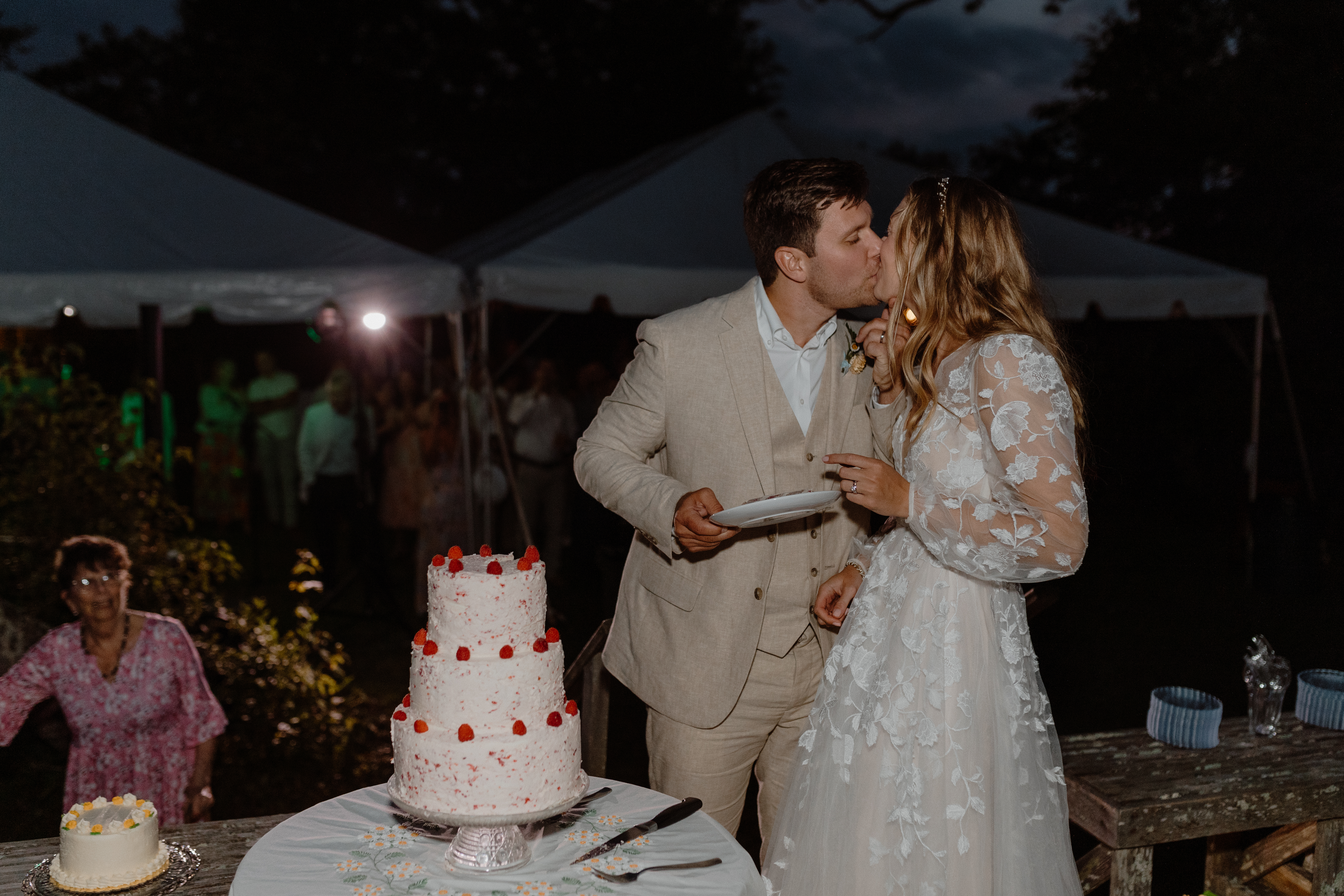 bride and groom kissing after cutting cake