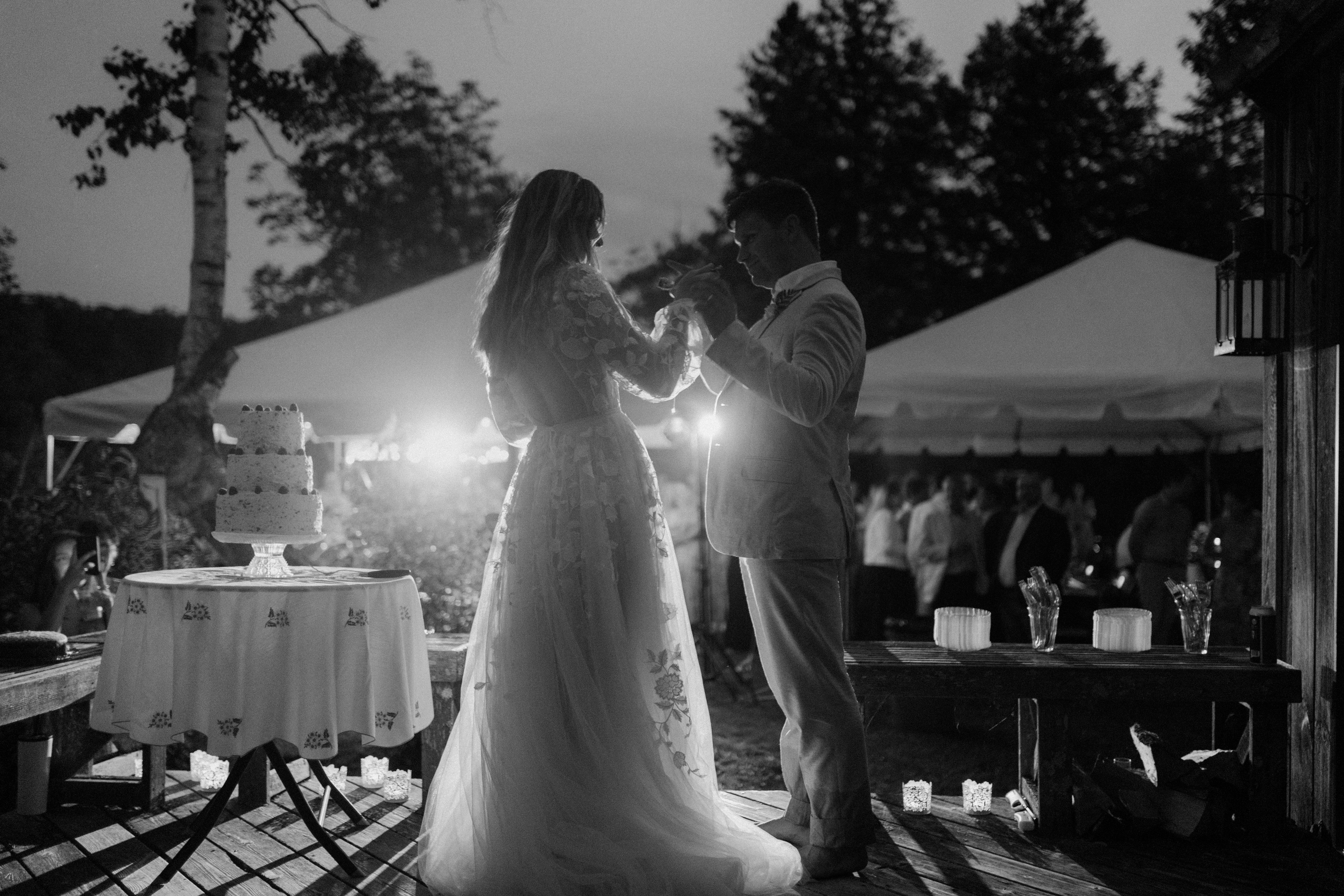 black and white photo of bride and groom's first dance at outdoor reception