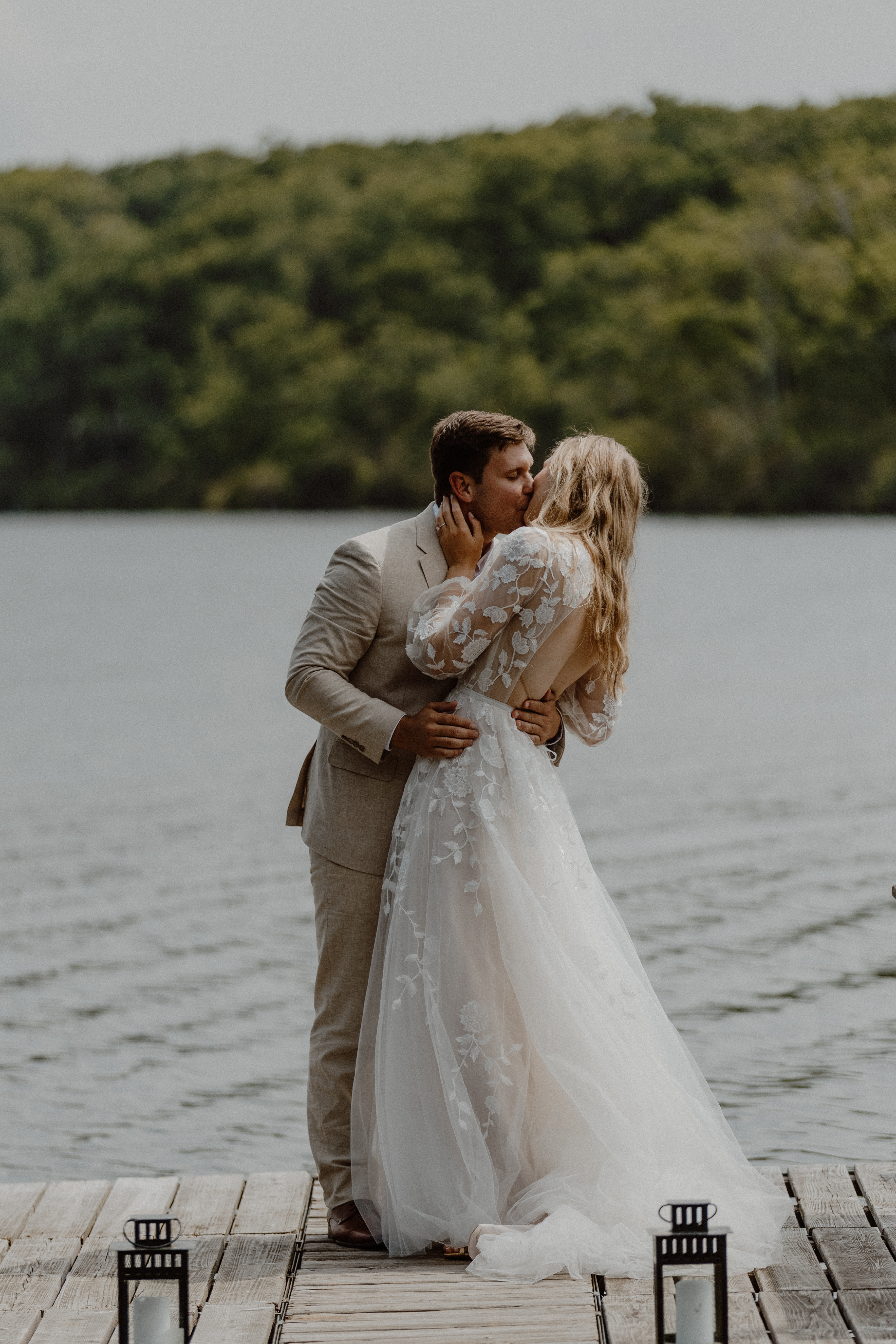 couple kissing in front of lake
