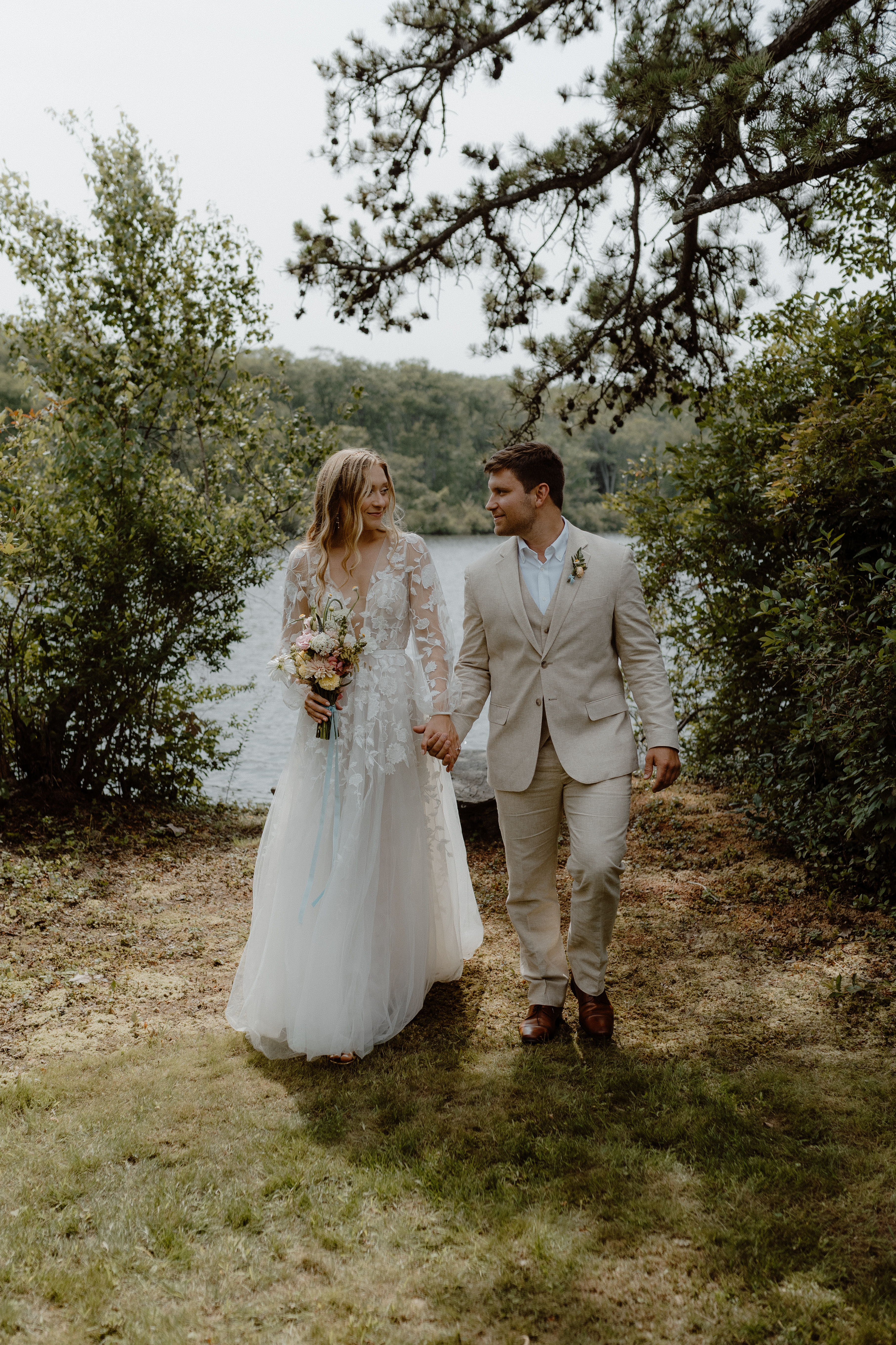 bride and groom holding hands and walking