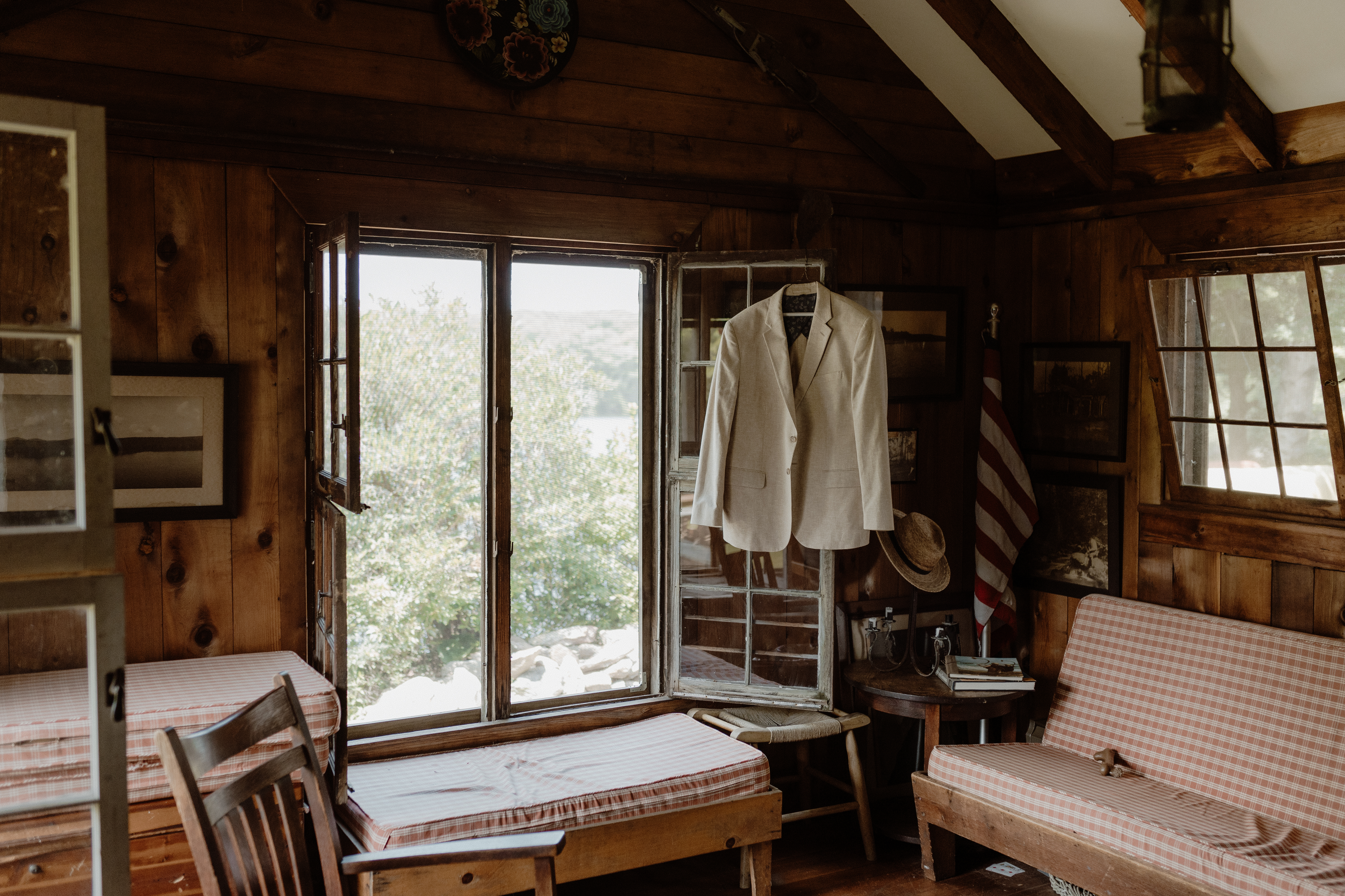 groom's suit jacket hanging on open cabin window