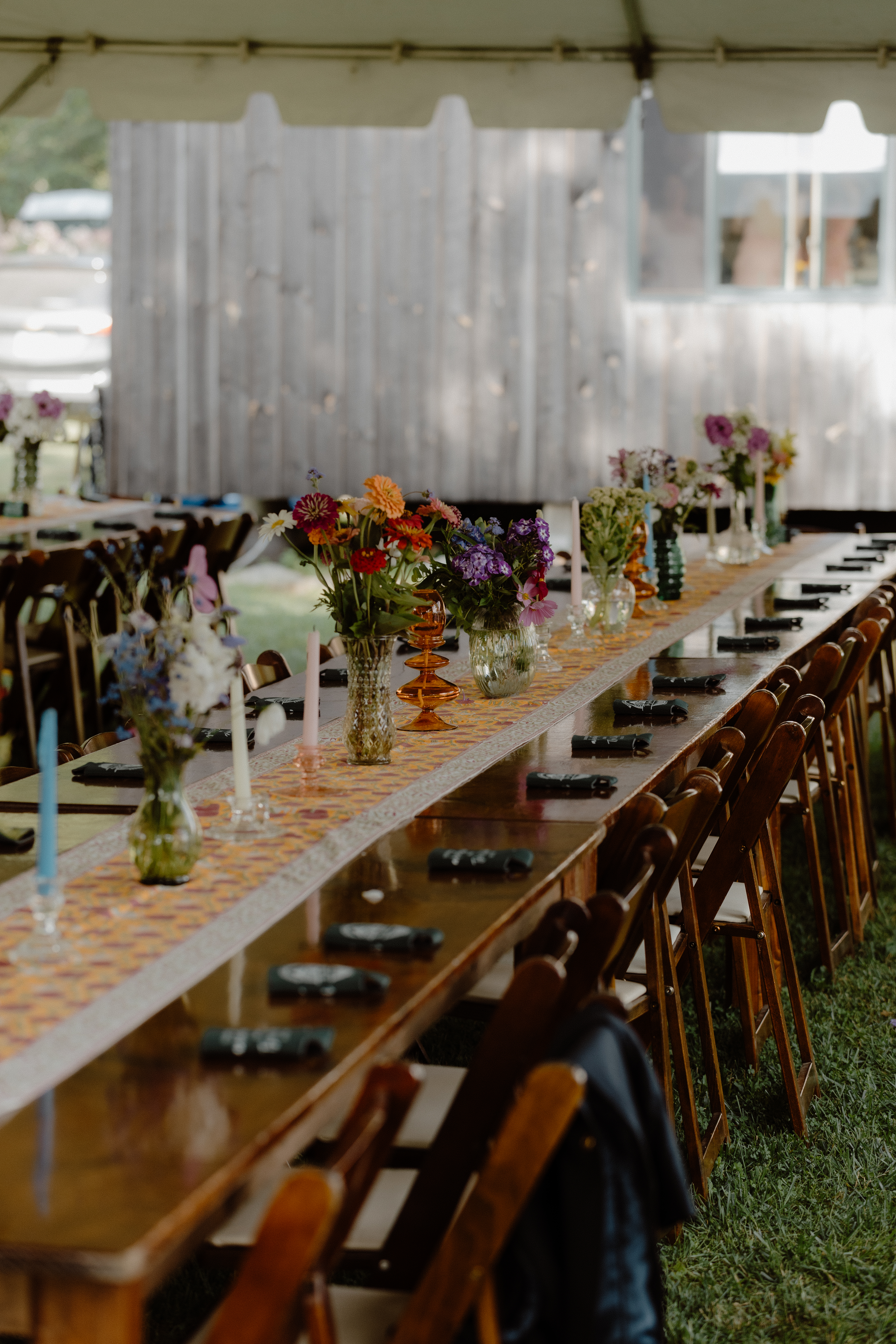 wooden wedding reception table with summer flowers