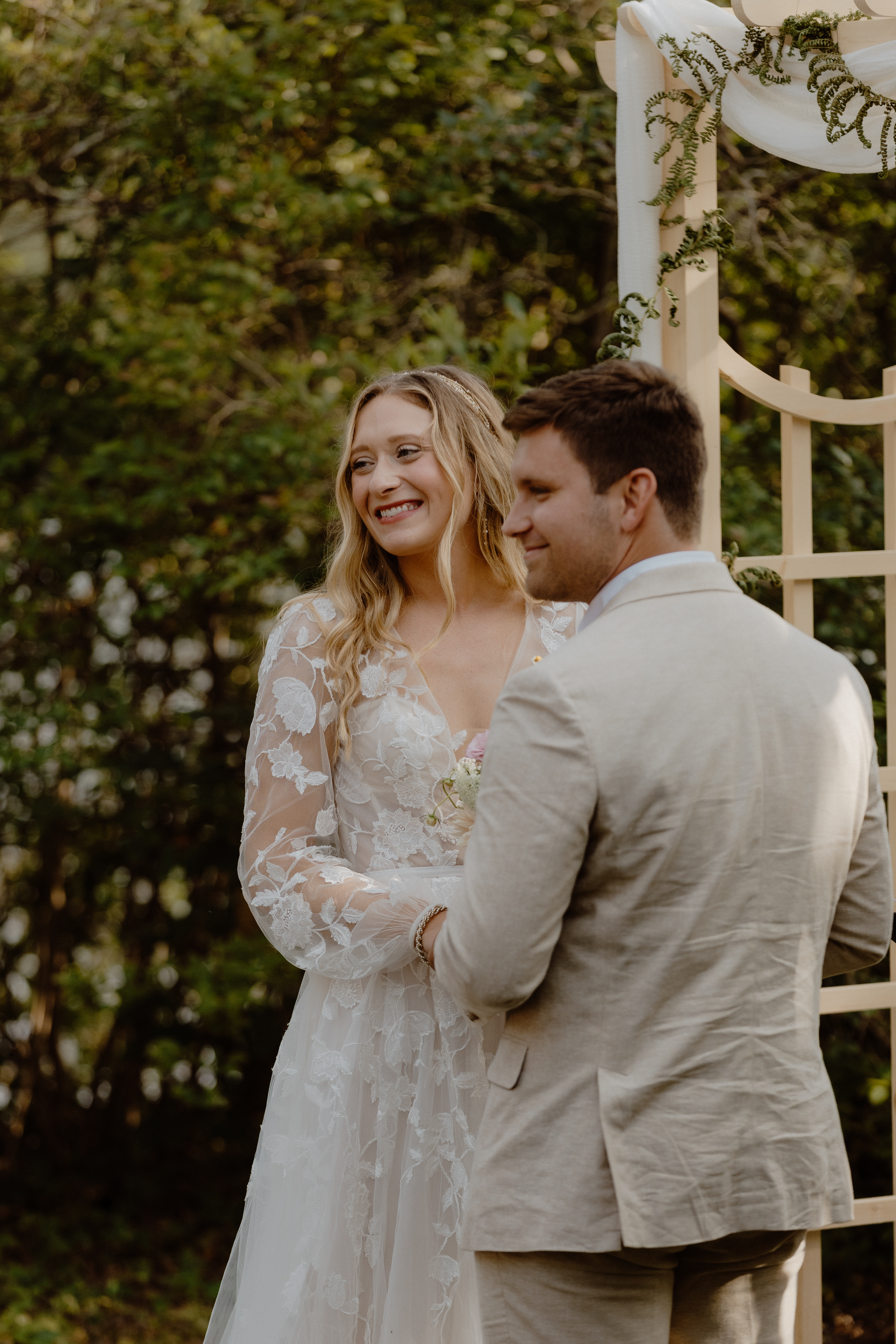 bride and groom smiling at altar