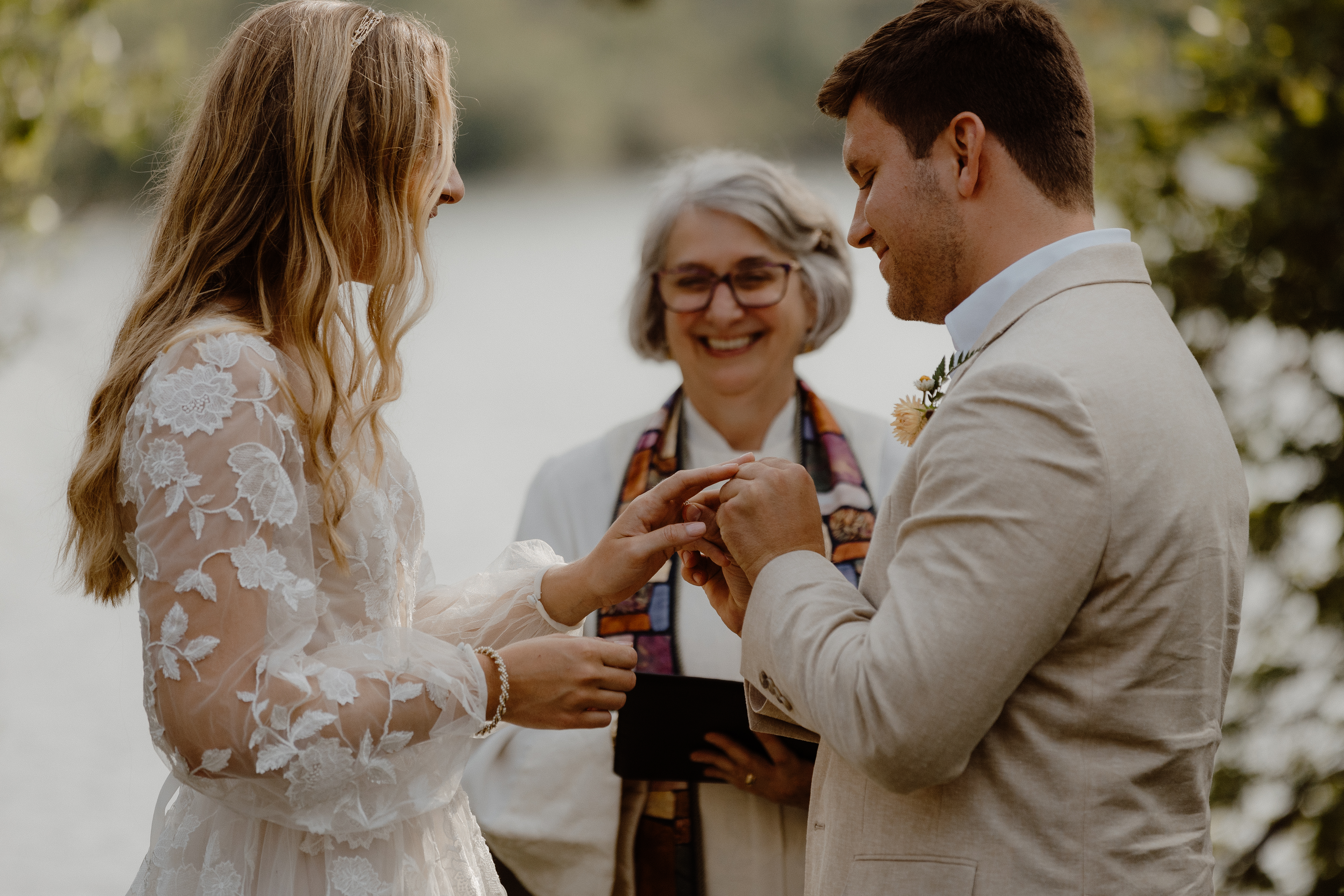 groom placing ring on bride's finger