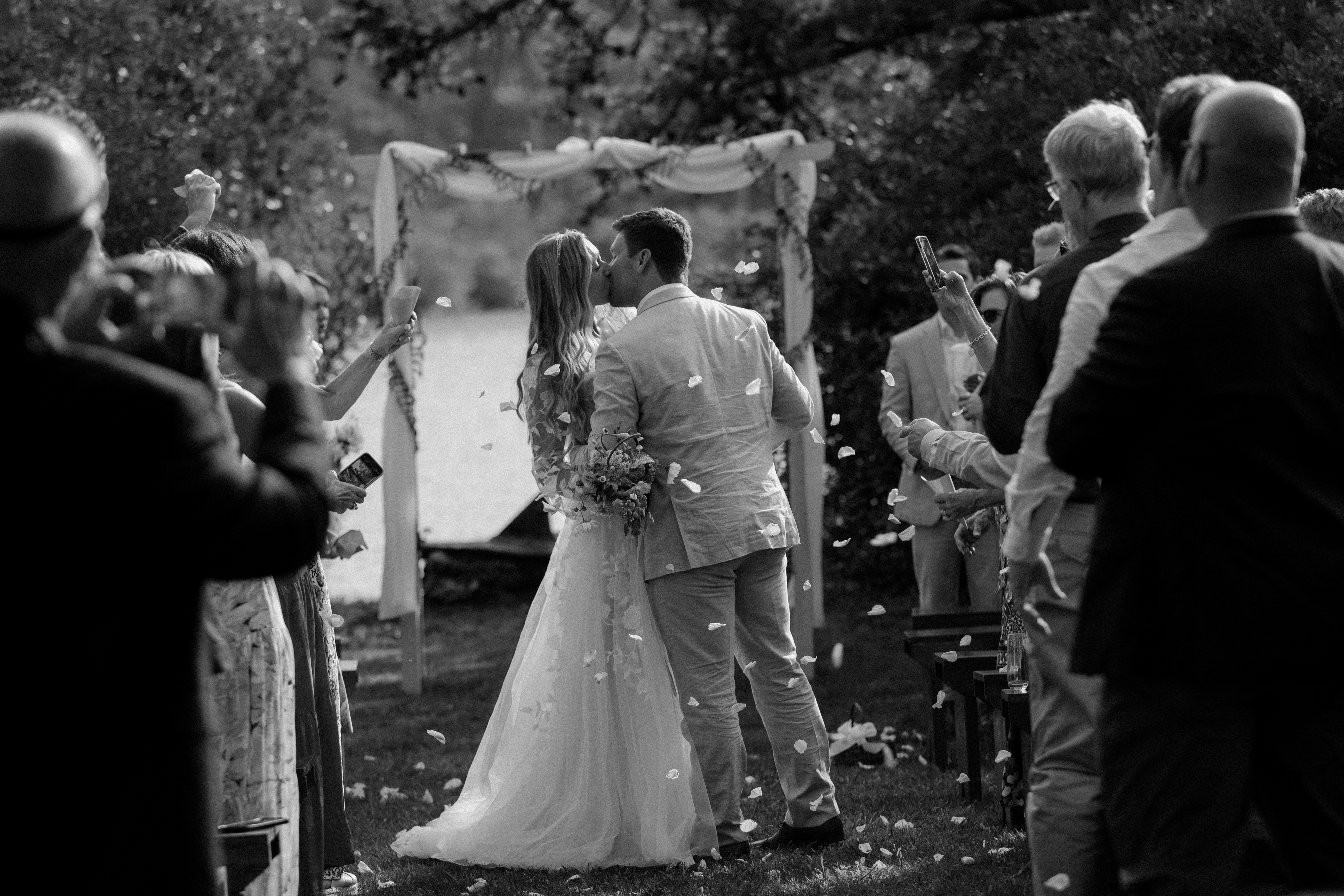 bride and groom kissing at altar