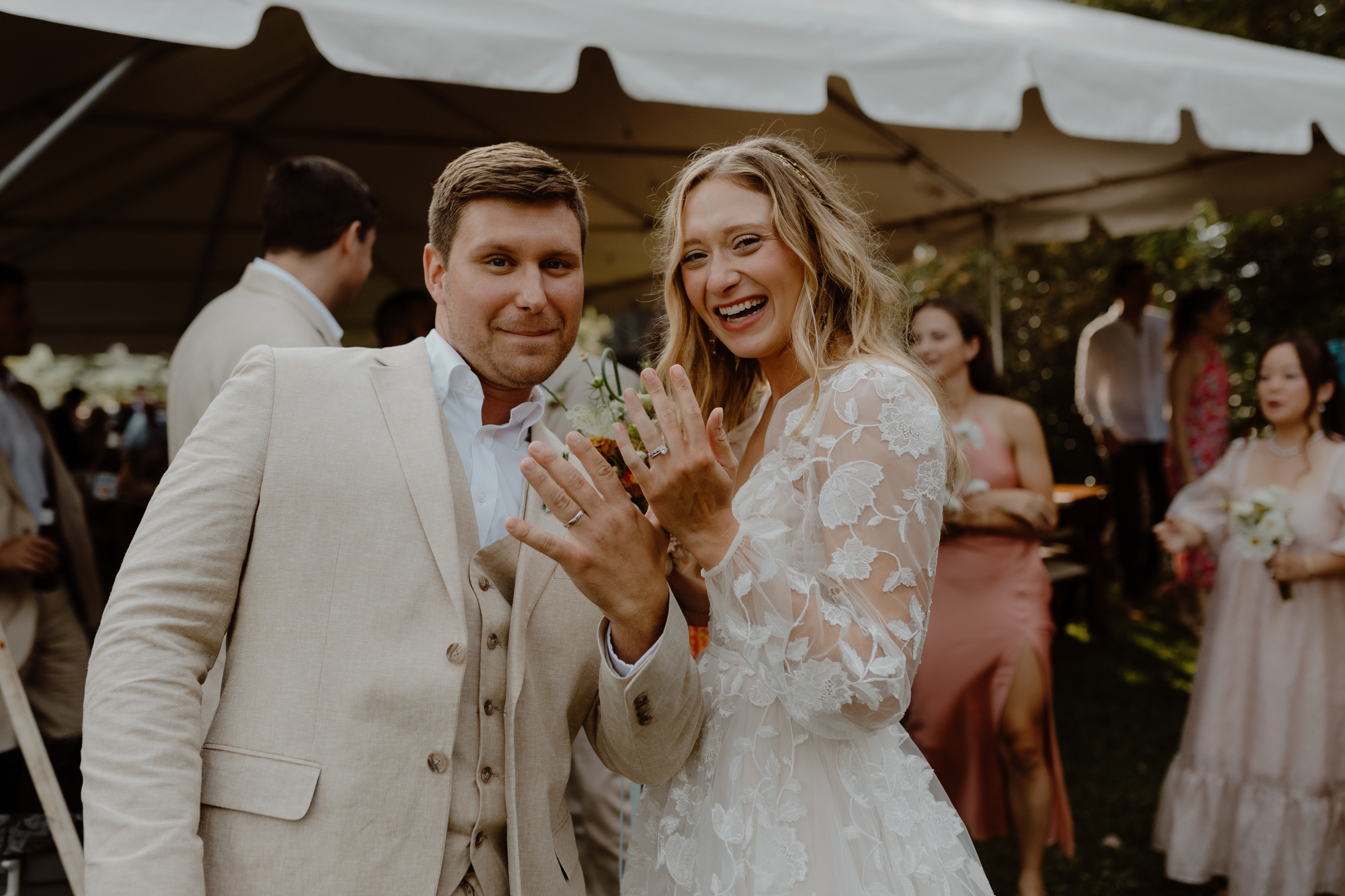 couple showing off wedding rings