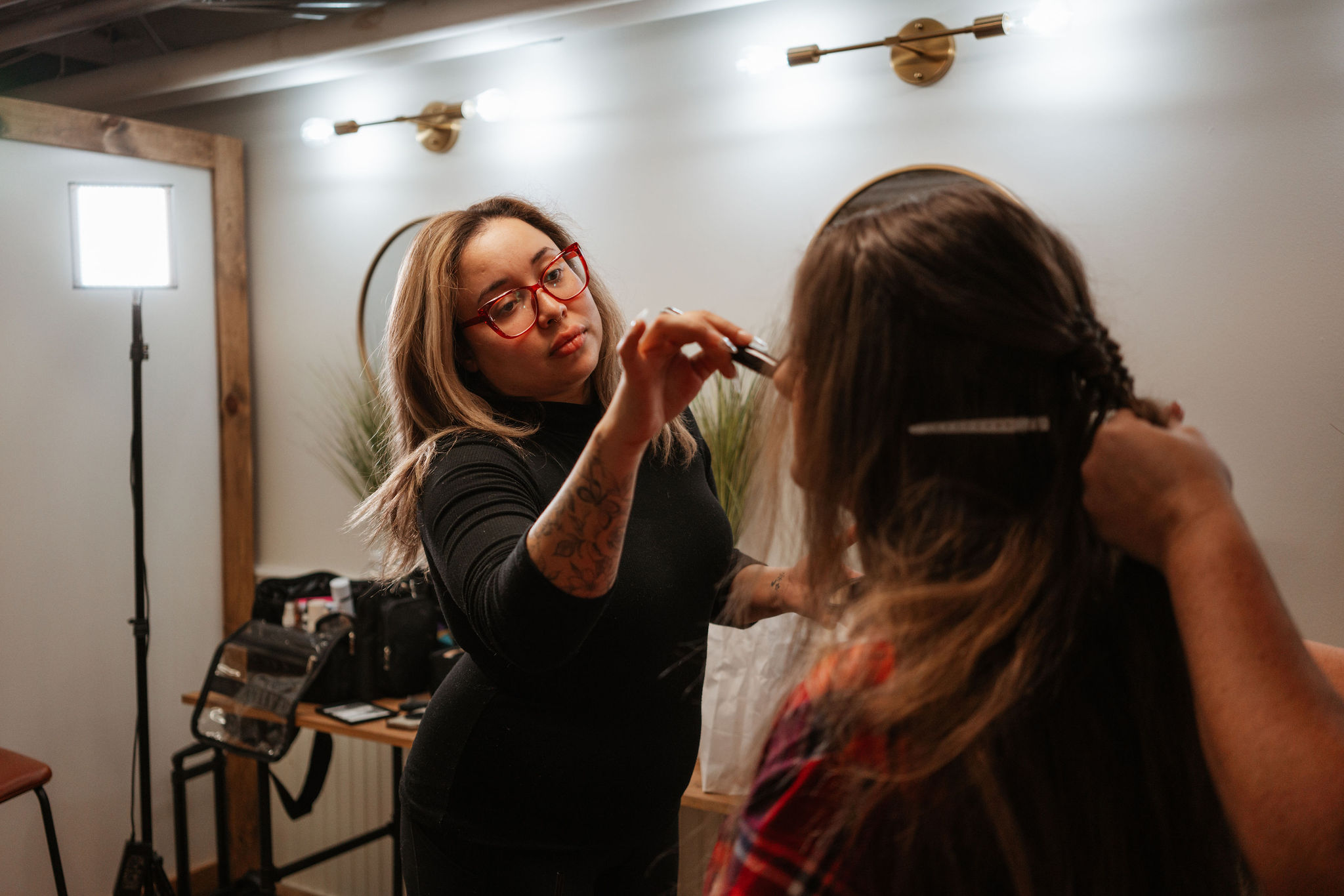 makeup artist and hair stylist working on bride