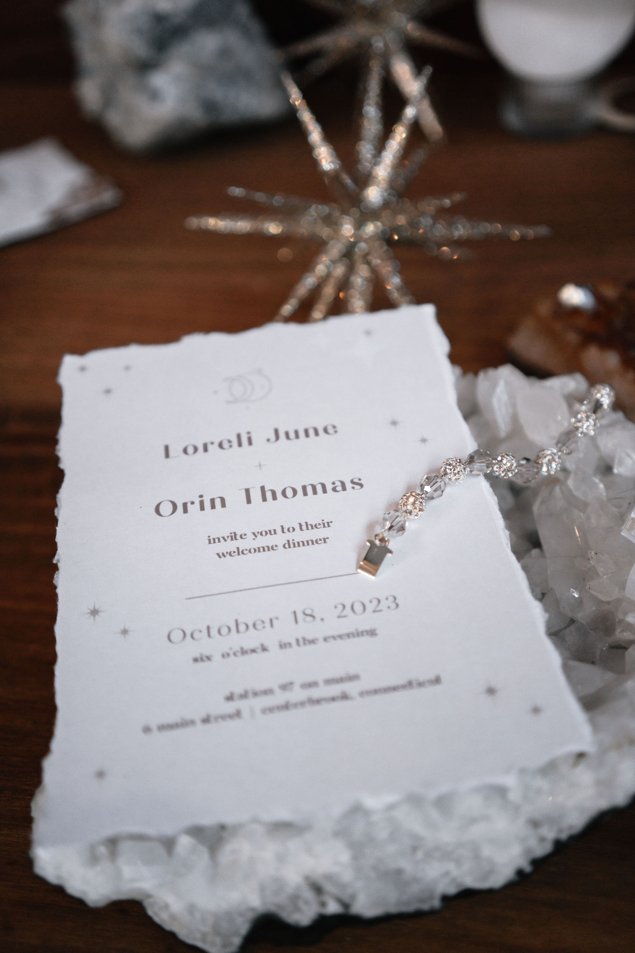 detail shot of bride's bracelet and wedding invite