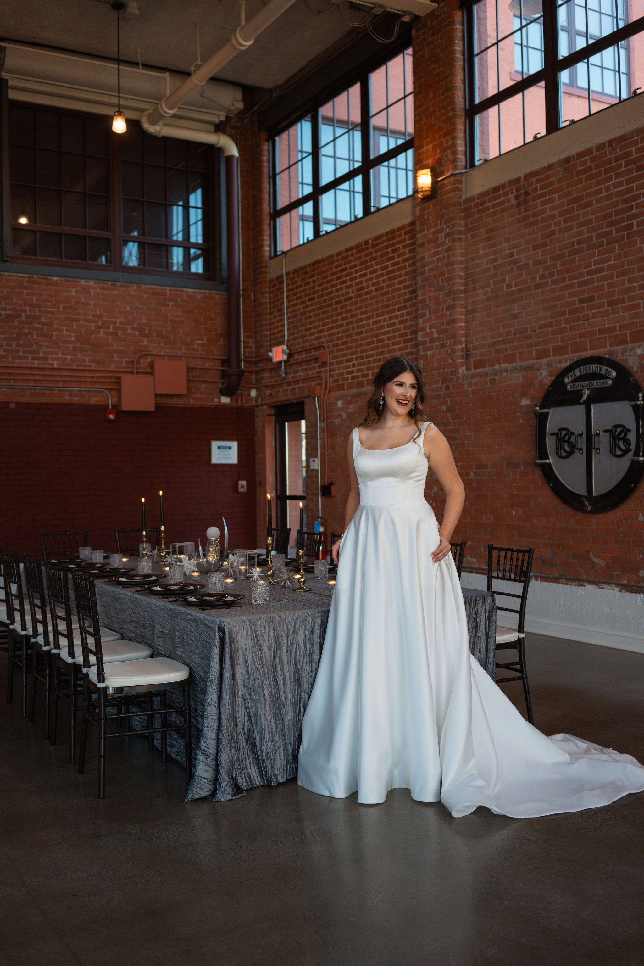 bride laughing in front of reception table