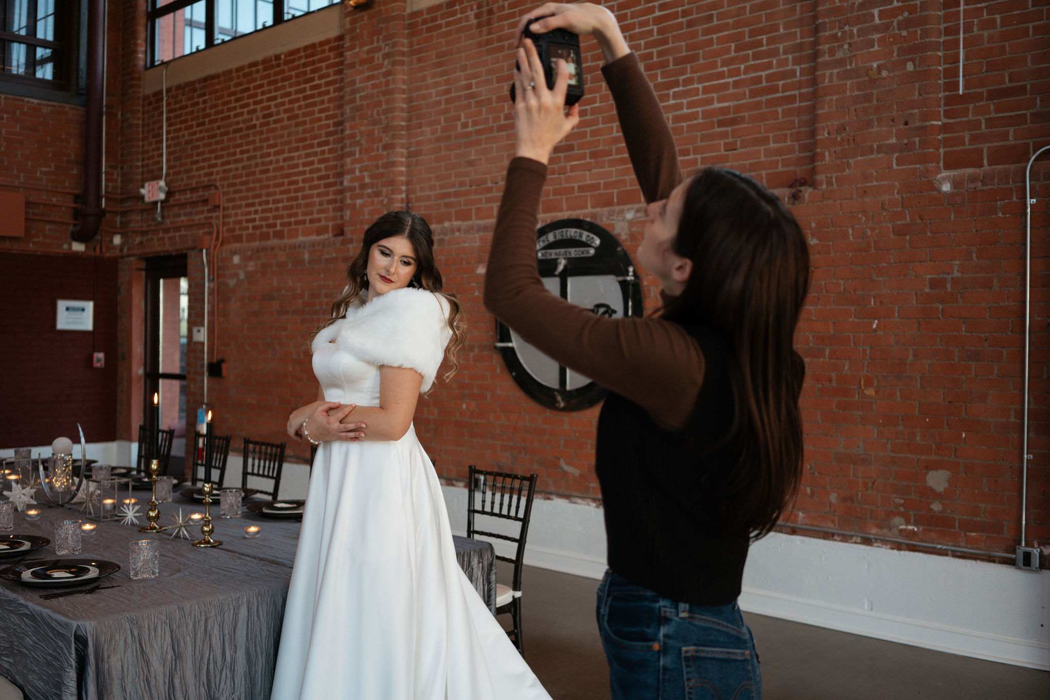 photographer taking picture of bride in front of seating