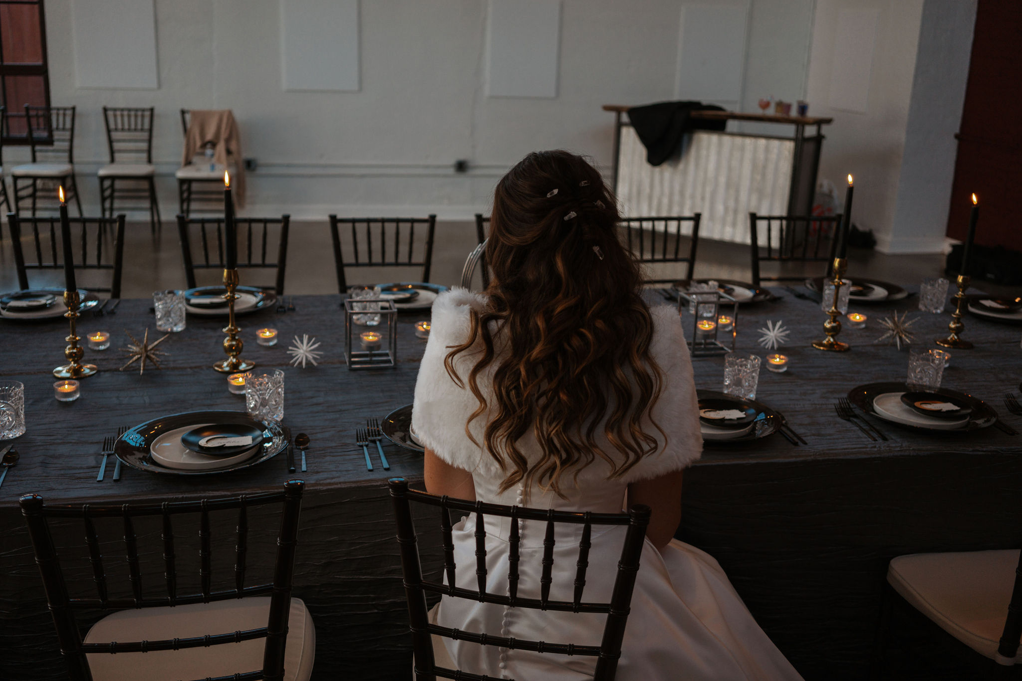 bride sitting at wedding reception tables