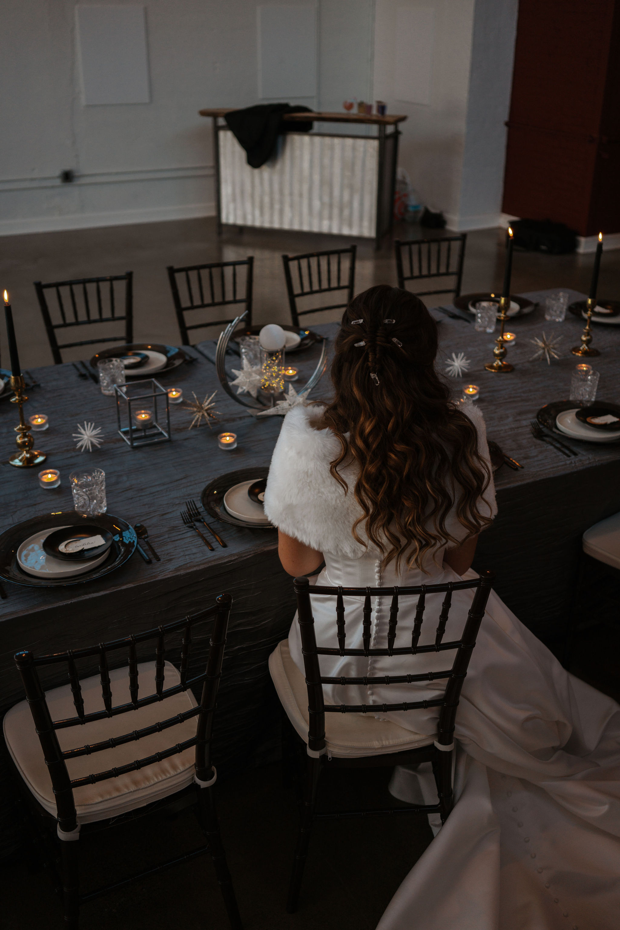 bride sitting at wedding reception tables with stars and moon theme