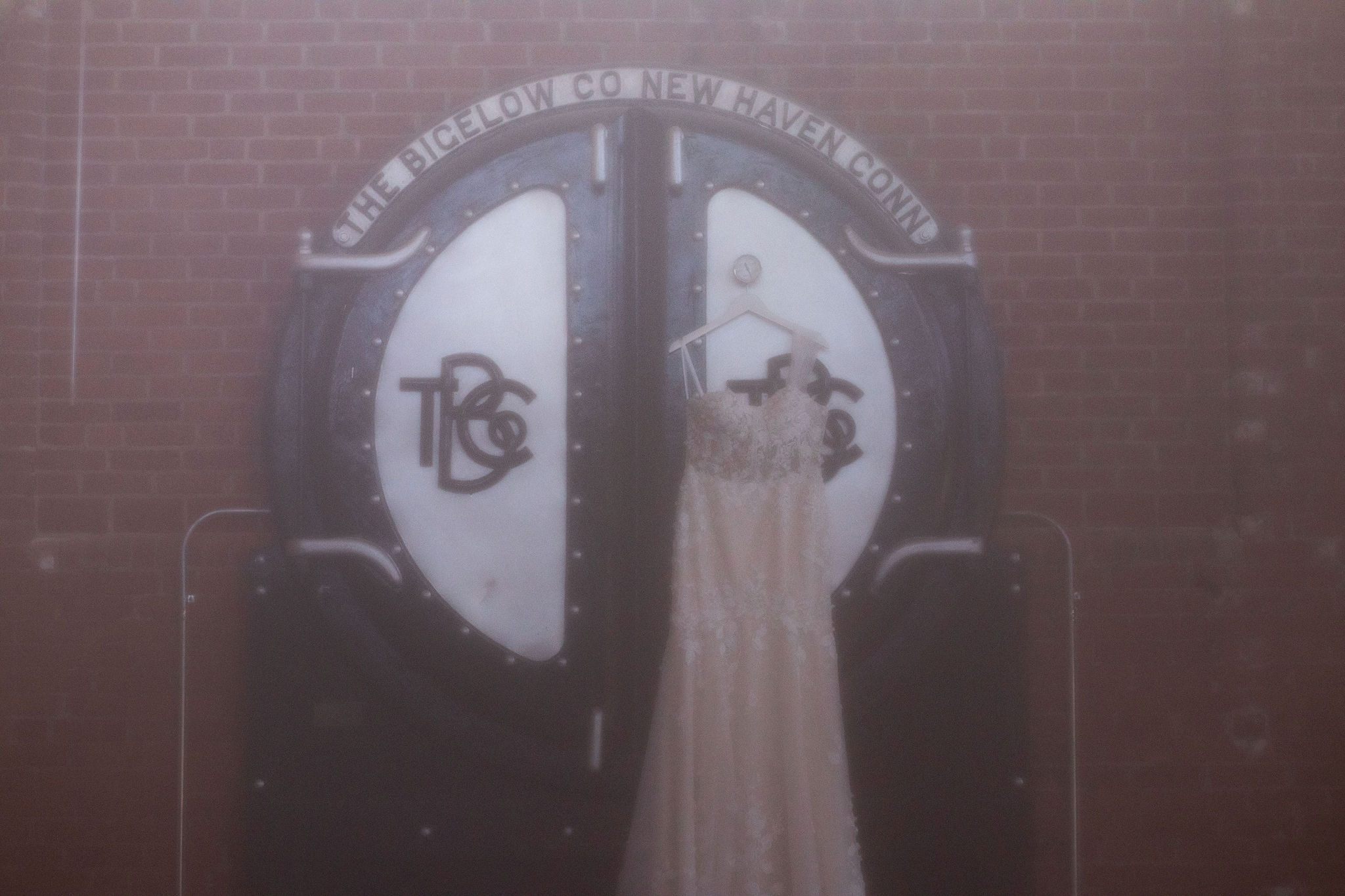wedding dress hanging up on venue sign